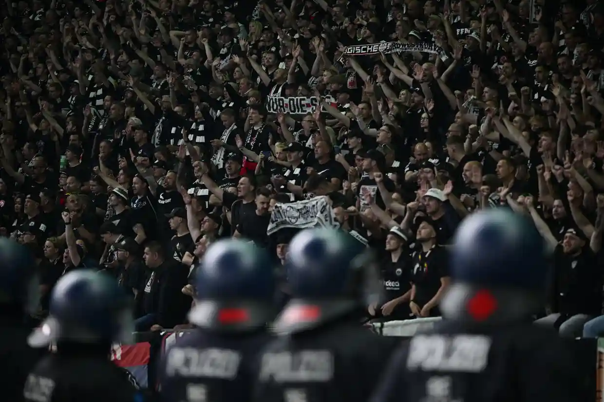 Riot police keep an eye on Frankfurt fans after a match against RB Leipzig. Photograph: John MacDougall/AFP/Getty Images.